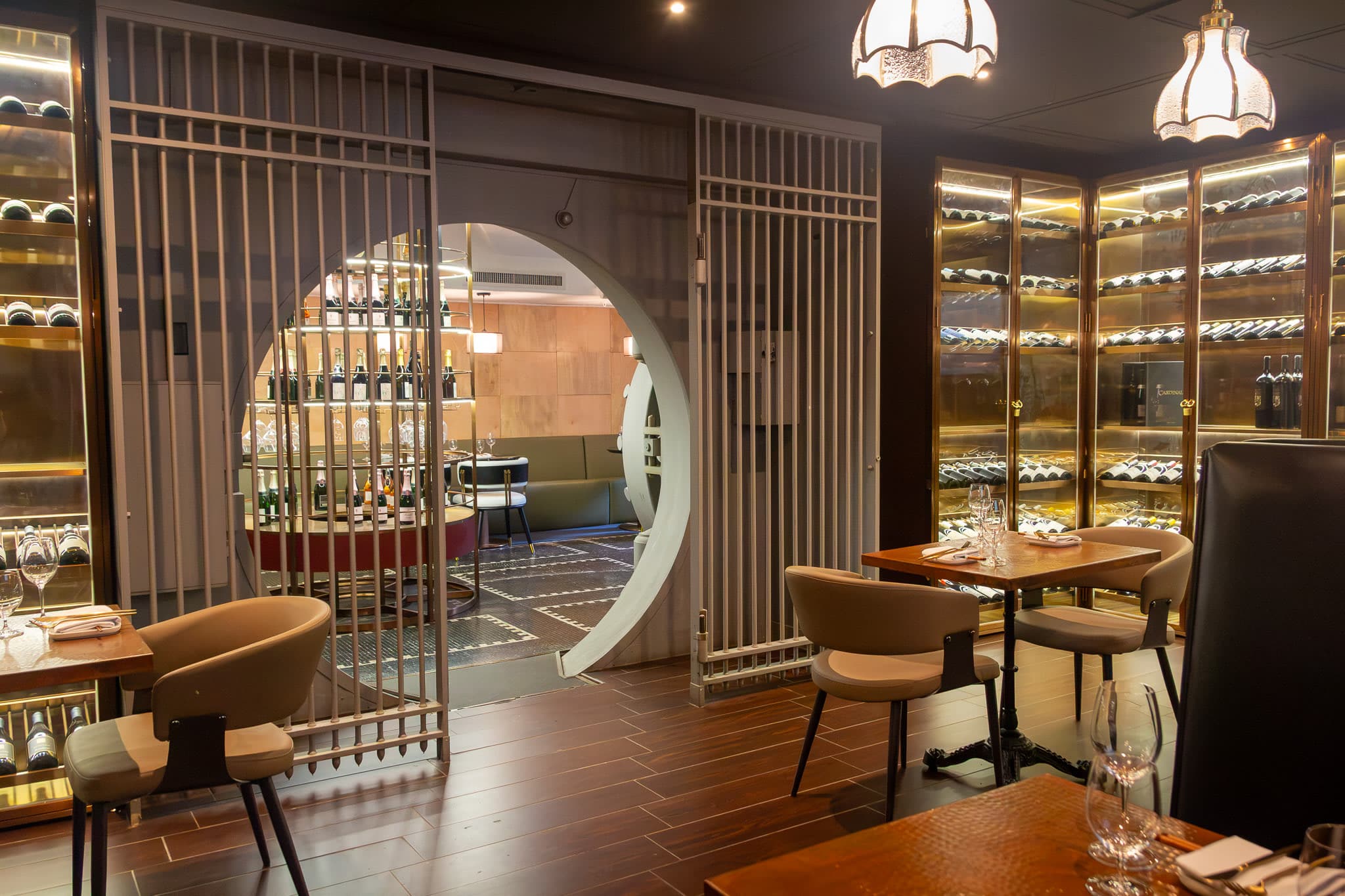 An intimate dining area framed by The Vault wine collection