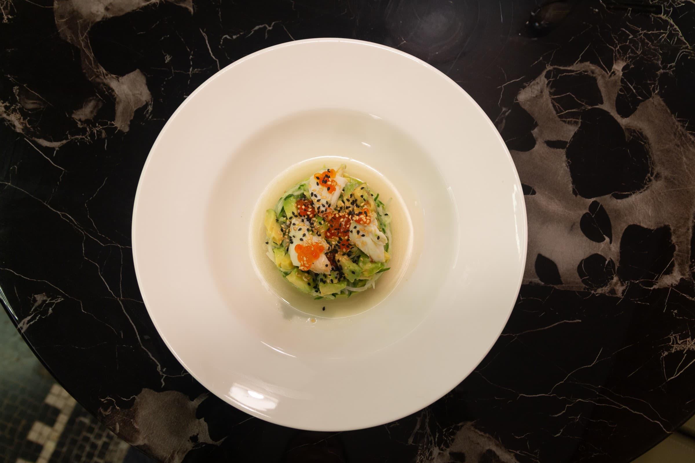 A composed dish presented on dark marble at The Vault